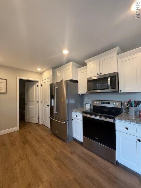 2519 Cortland Dr, Jackson, MO 63755 - kitchen with stainless steel appliances, white cabinets, dark wood-style flooring, and recessed lighting