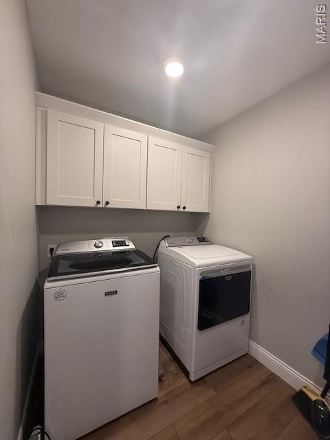 2519 Cortland Dr, Jackson, MO 63755 - laundry area featuring cabinet space, independent washer and dryer, and light wood-style flooring