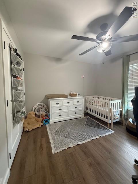 2519 Cortland Dr, Jackson, MO 63755 - bedroom featuring wood finished floors, ceiling fan, and a crib