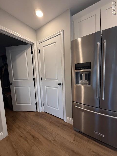 2519 Cortland Dr, Jackson, MO 63755 - kitchen with high end fridge, white cabinetry, and wood finished floors