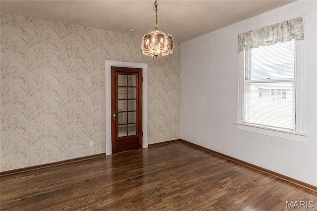 711 Erskine Ave, Lemay Township, MO 63125 - spare room with a chandelier, wood finished floors, and wallpapered walls