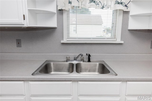 711 Erskine Ave, Lemay Township, MO 63125 - kitchen with open shelves, white cabinetry, and light countertops