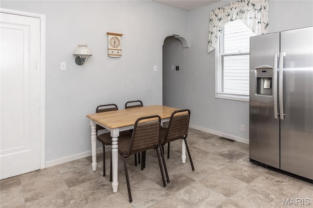 711 Erskine Ave, Lemay Township, MO 63125 - dining space featuring arched walkways and baseboards