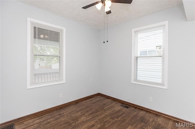 711 Erskine Ave, Lemay Township, MO 63125 - empty room featuring dark wood-type flooring and ceiling fan