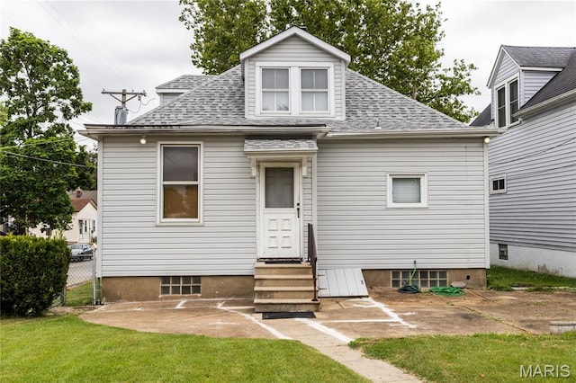 711 Erskine Ave, Lemay Township, MO 63125 - rear view of property featuring entry steps, a patio, a shingled roof, and a lawn