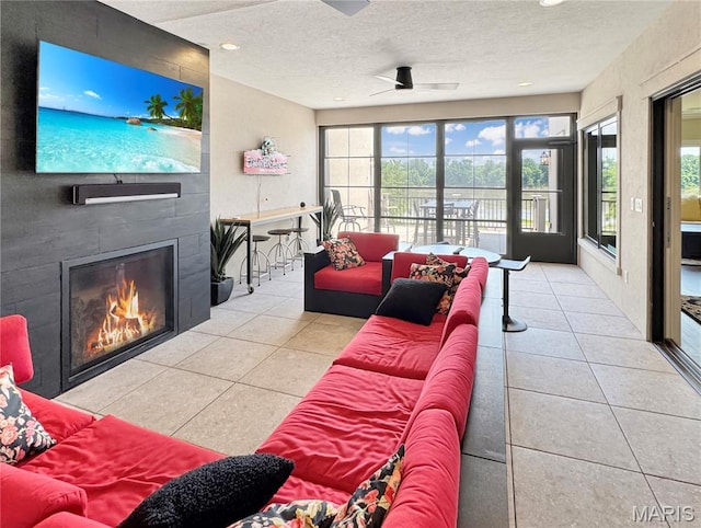 4 Market St, Washington, MO 63090 - tiled living room featuring a glass covered fireplace, a textured ceiling, and recessed lighting