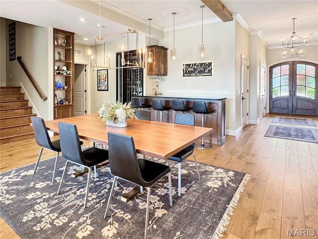 4 Market St, Washington, MO 63090 - dining room with french doors, a chandelier, light wood finished floors, stairs, and crown molding