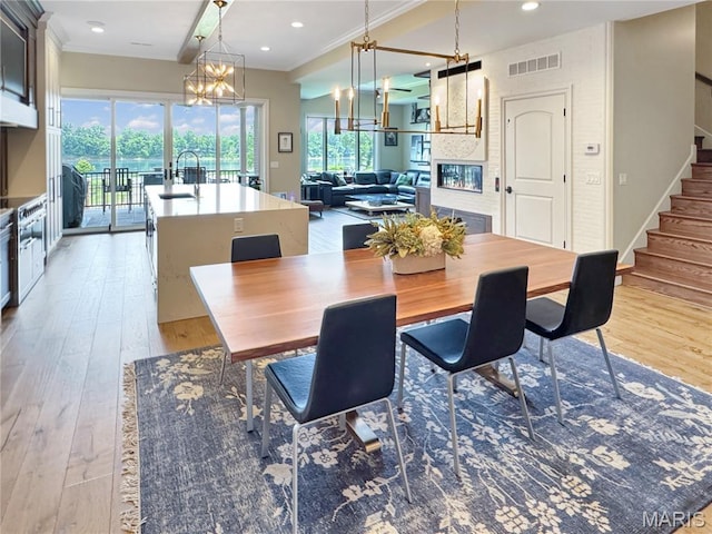 4 Market St, Washington, MO 63090 - dining space featuring stairway, ornamental molding, a chandelier, light wood-type flooring, and recessed lighting