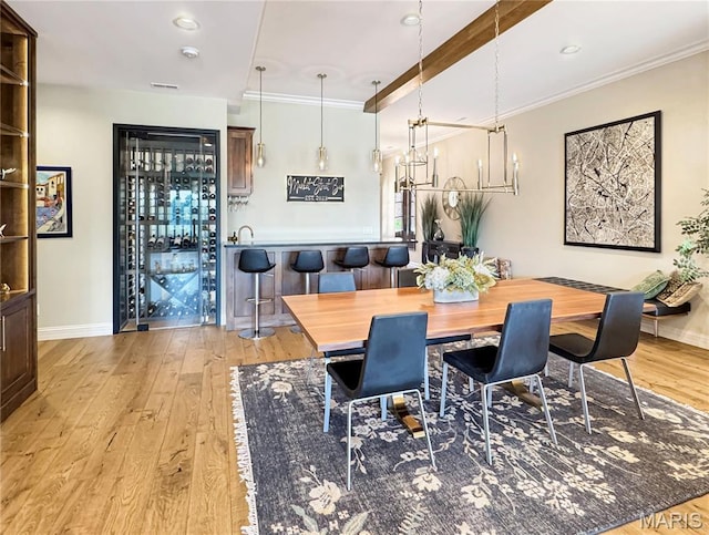 4 Market St, Washington, MO 63090 - dining room featuring light wood-type flooring, ornamental molding, a chandelier, and recessed lighting