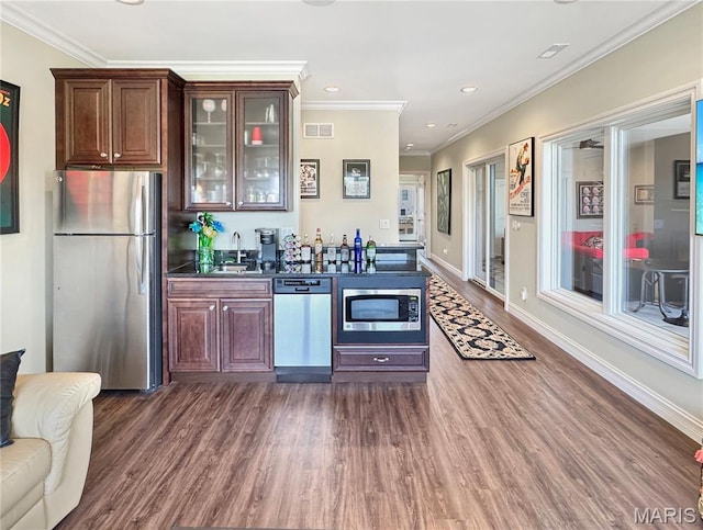 4 Market St, Washington, MO 63090 - indoor wet bar featuring stainless steel appliances, dark wood-type flooring, ornamental molding, and recessed lighting
