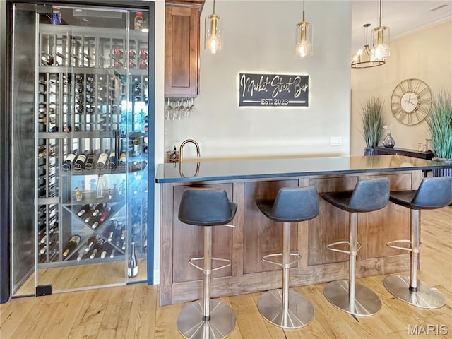 4 Market St, Washington, MO 63090 - indoor dry bar with wood finished floors, decorative light fixtures, and crown molding