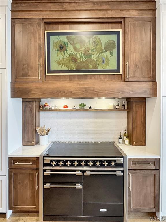 4 Market St, Washington, MO 63090 - kitchen featuring range with two ovens, tasteful backsplash, open shelves, and light stone counters