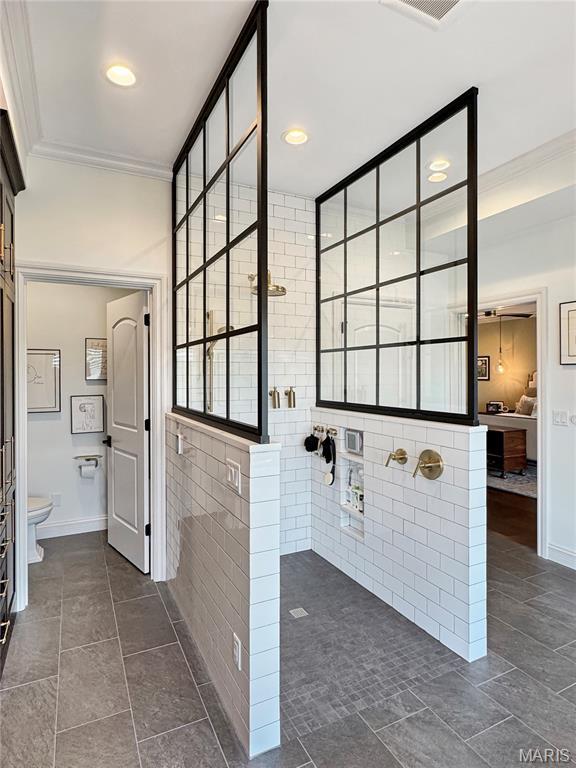 4 Market St, Washington, MO 63090 - ensuite bathroom featuring ornamental molding, walk in shower, tile patterned floors, and recessed lighting