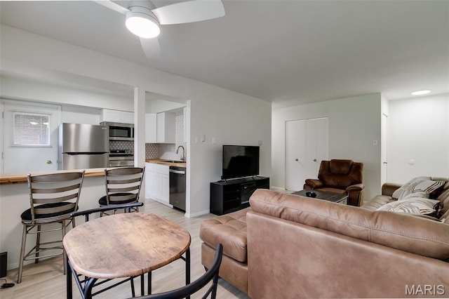 8733 Sieloff Dr Unit C, Hazelwood, MO 63042 - living area with light wood finished floors and ceiling fan