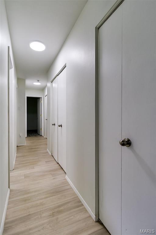 8733 Sieloff Dr Unit C, Hazelwood, MO 63042 - corridor featuring light wood-style flooring and baseboards