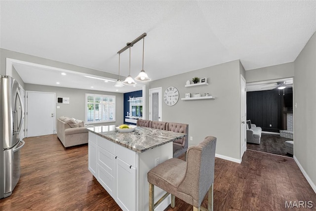 1002 Arlington Dr, Saint Charles, MO 63303 - kitchen featuring freestanding refrigerator, open floor plan, dark wood-type flooring, white cabinets, and light stone countertops