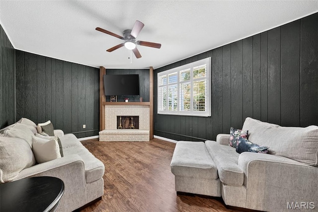 1002 Arlington Dr, Saint Charles, MO 63303 - living room featuring a ceiling fan, wooden walls, a fireplace, and wood finished floors
