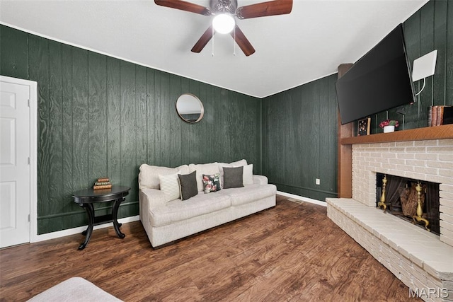 1002 Arlington Dr, Saint Charles, MO 63303 - living area featuring a brick fireplace, wood finished floors, ceiling fan, and wood walls