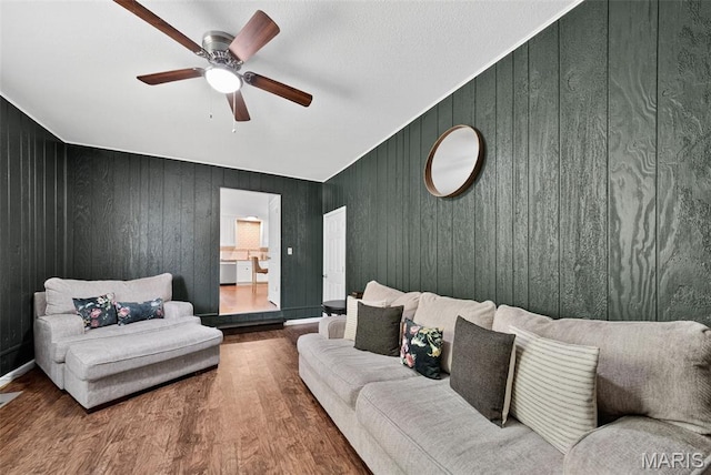1002 Arlington Dr, Saint Charles, MO 63303 - living room with ceiling fan, wood finished floors, and wooden walls