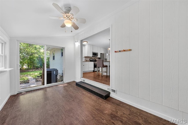 1002 Arlington Dr, Saint Charles, MO 63303 - unfurnished living room featuring dark wood-type flooring, a ceiling fan, and vaulted ceiling