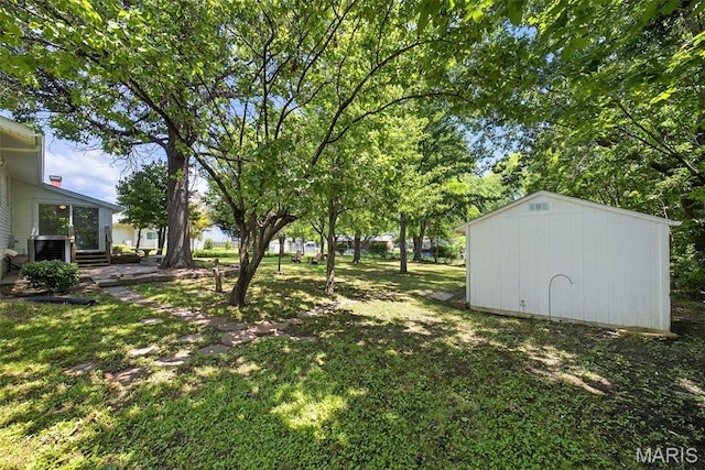1002 Arlington Dr, Saint Charles, MO 63303 - view of grassy yard with a storage unit