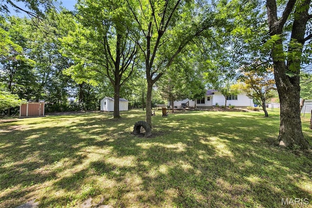 1002 Arlington Dr, Saint Charles, MO 63303 - view of grassy yard with a storage shed