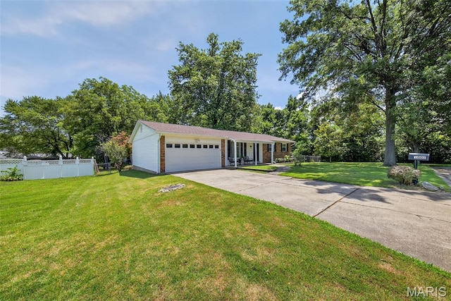 1002 Arlington Dr, Saint Charles, MO 63303 - ranch-style house with a garage, concrete driveway, and view of wooded area
