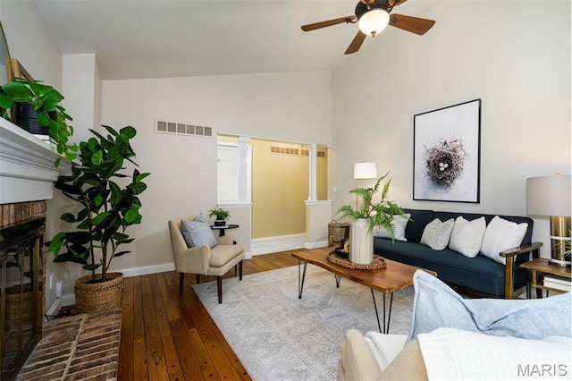 1730 Blakefield Ter, Manchester, MO 63021 - living room with hardwood / wood-style flooring, ceiling fan, a brick fireplace, and high vaulted ceiling