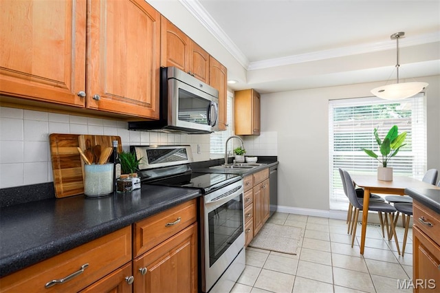 1730 Blakefield Ter, Manchester, MO 63021 - kitchen with crown molding, appliances with stainless steel finishes, backsplash, brown cabinetry, and dark countertops