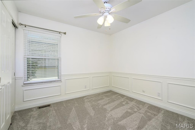 1730 Blakefield Ter, Manchester, MO 63021 - unfurnished room featuring carpet, plenty of natural light, wainscoting, ceiling fan, and a decorative wall