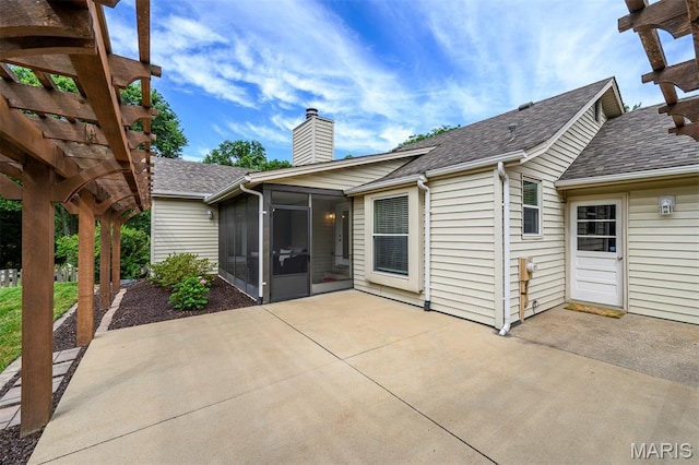 1730 Blakefield Ter, Manchester, MO 63021 - rear view of house featuring a sunroom, a patio, a chimney, and a shingled roof