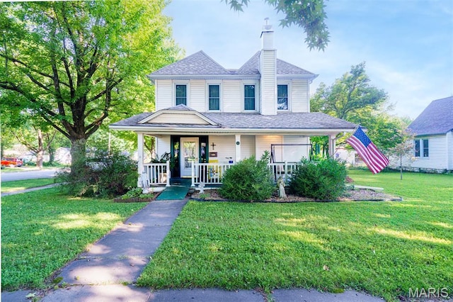 131 W James Blvd, St James, MO 65559 - view of front of home featuring a chimney, a front lawn, covered porch, and a shingled roof