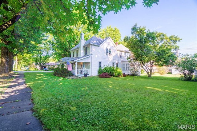 131 W James Blvd, St James, MO 65559 - view of side of home featuring a chimney, a lawn, and a porch