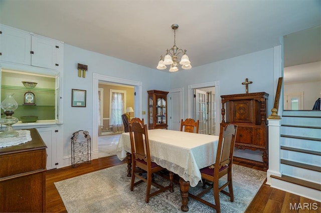 131 W James Blvd, St James, MO 65559 - dining area featuring dark wood-style flooring, a chandelier, and stairs