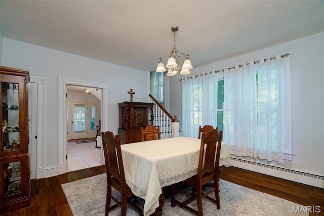 131 W James Blvd, St James, MO 65559 - dining area with a baseboard heating unit, a chandelier, and wood finished floors