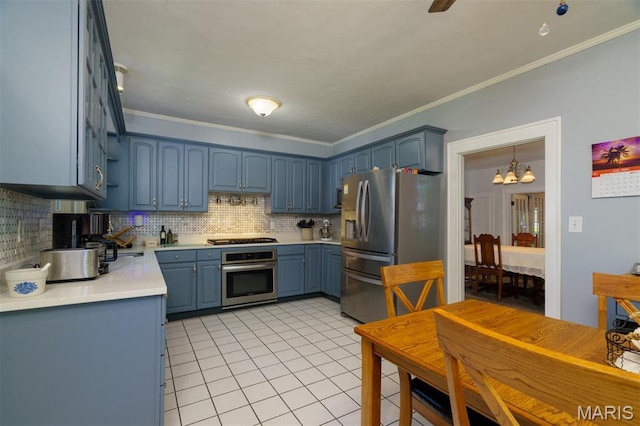 131 W James Blvd, St James, MO 65559 - kitchen with stainless steel appliances, blue cabinetry, a chandelier, ornamental molding, and backsplash