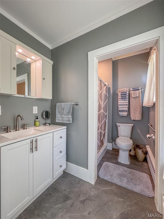 131 W James Blvd, St James, MO 65559 - full bathroom with ornamental molding, vanity, a shower with curtain, and a baseboard radiator