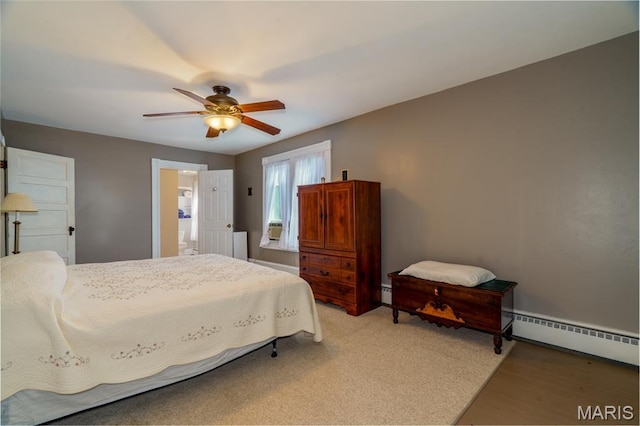 131 W James Blvd, St James, MO 65559 - bedroom featuring baseboard heating, a ceiling fan, a baseboard radiator, and connected bathroom