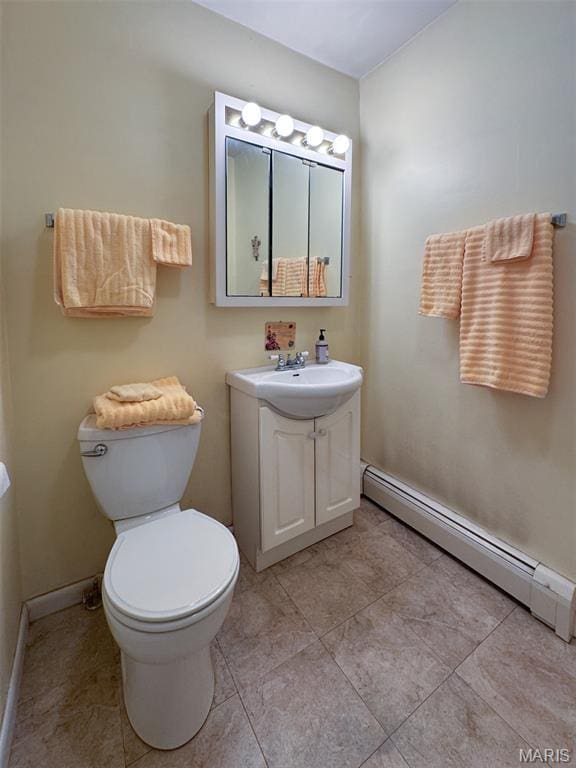 131 W James Blvd, St James, MO 65559 - bathroom with a baseboard heating unit, vanity, and tile patterned flooring