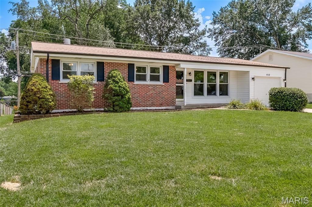 412 Elmwood Dr, Saint Charles, MO 63301 - single story home with a garage, a front yard, and brick siding