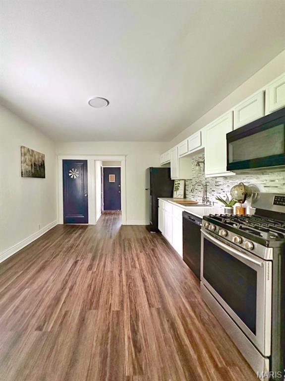 1604 Quendo Ave, Saint Louis, MO 63130 - kitchen with black appliances, white cabinets, dark wood-style floors, and decorative backsplash