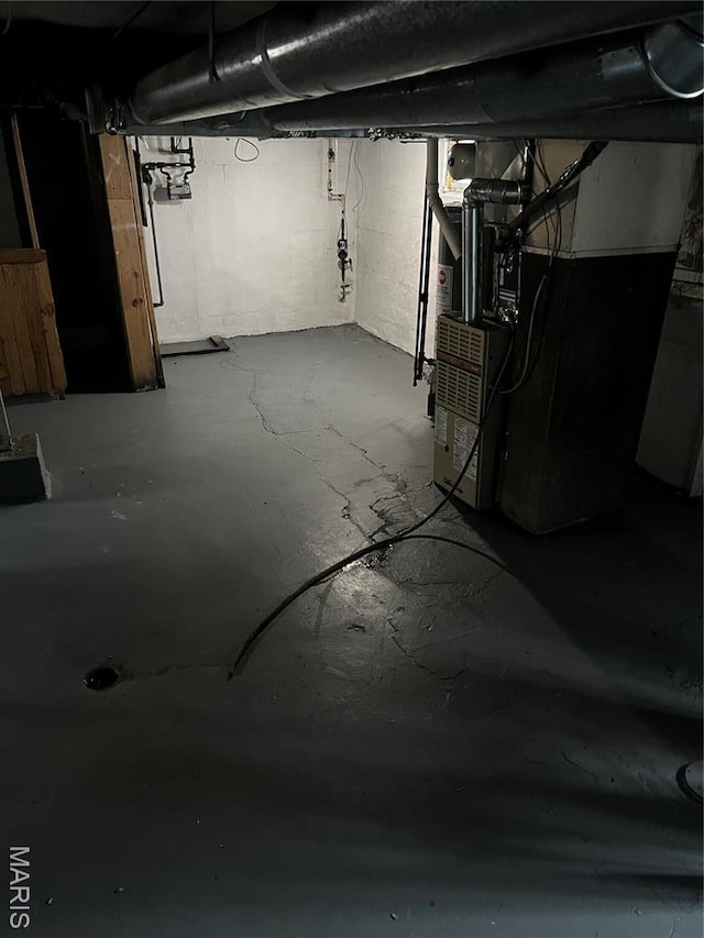 5209 College Ave, Jennings, MO 63136 - unfinished basement featuring heating unit and gas meter
