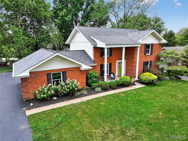 538 Kenilworth Ln, Ballwin, MO 63011 - greek revival house featuring a front lawn, brick siding, and roof with shingles