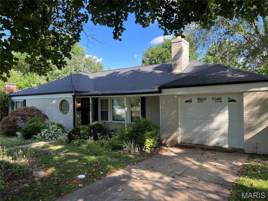 430 Cannonbury Dr, Webster Groves, MO 63119 - ranch-style home with brick siding, a chimney, a garage, concrete driveway, and roof with shingles