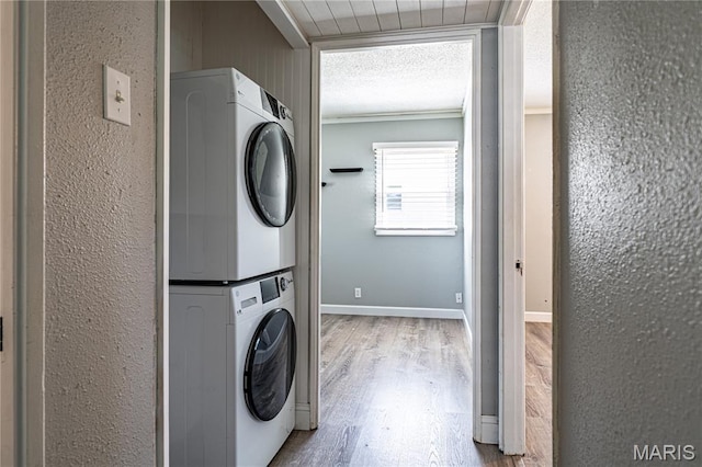 2004 Cottage Ave, Granite City, IL 62040 - laundry room featuring stacked washer / drying machine, wood finished floors, ornamental molding, and a textured wall