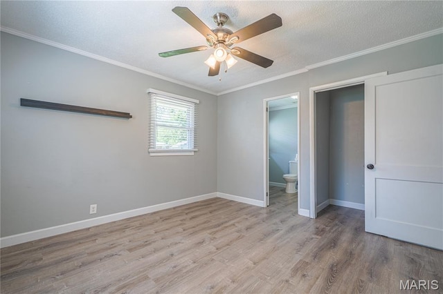 2004 Cottage Ave, Granite City, IL 62040 - unfurnished bedroom with light wood-type flooring, crown molding, a ceiling fan, ensuite bath, and a textured ceiling