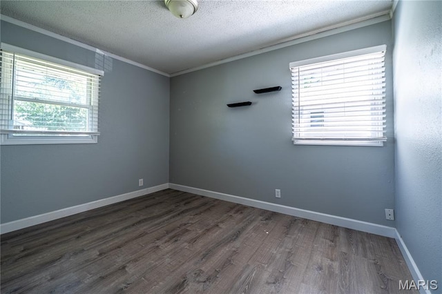 2004 Cottage Ave, Granite City, IL 62040 - empty room with healthy amount of natural light, wood finished floors, a textured ceiling, and ornamental molding