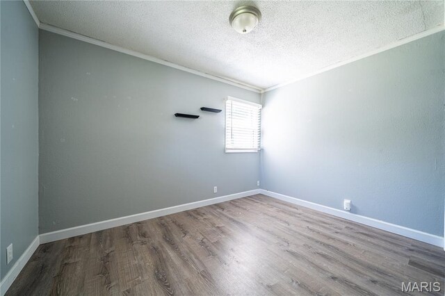 2004 Cottage Ave, Granite City, IL 62040 - spare room featuring crown molding, a textured ceiling, and wood finished floors