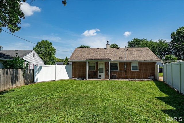 2004 Cottage Ave, Granite City, IL 62040 - rear view of house with a fenced backyard, brick siding, and a chimney