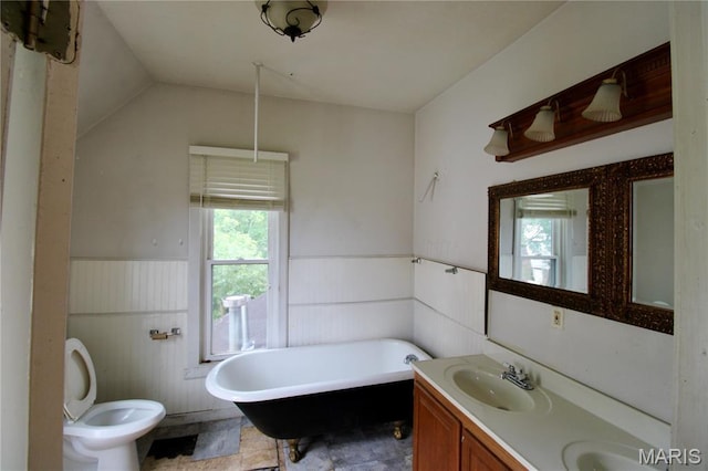 814 Vine St, Poplar Bluff, MO 63901 - bathroom featuring wainscoting, a freestanding bath, double vanity, and lofted ceiling